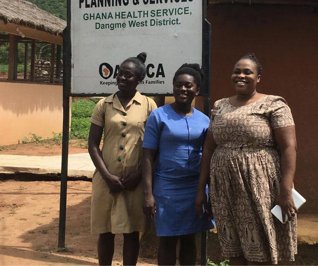 Three community health workers outside of a health facility near Accra, Ghana